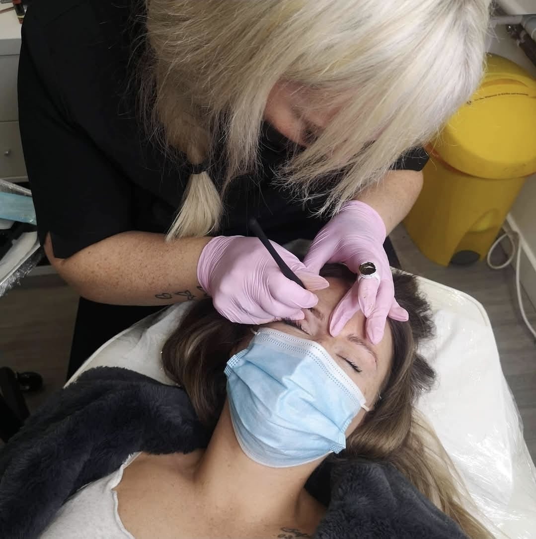 Semi-permanent makeup brow treatment being carried out by a qualified practitioner